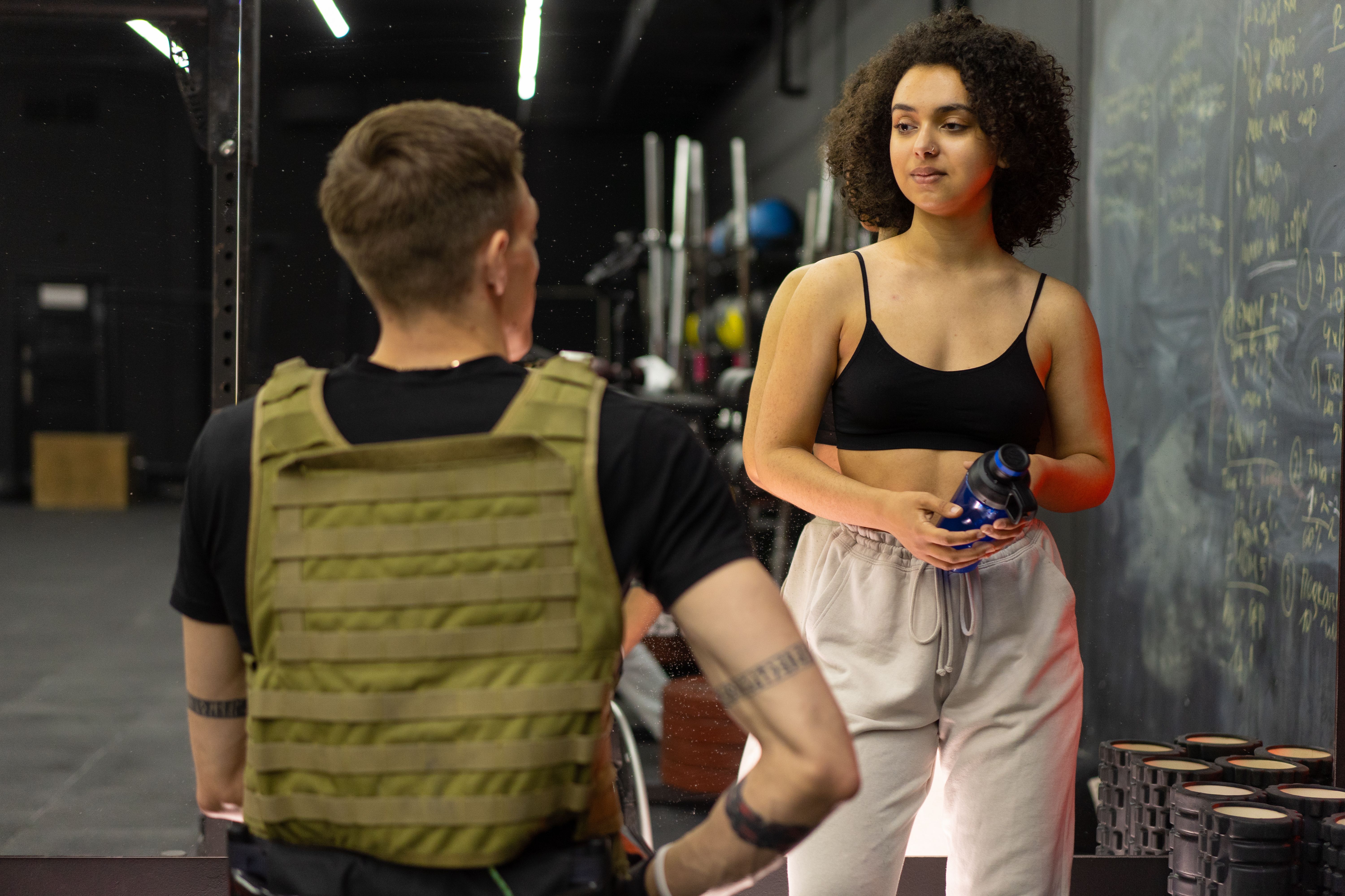 Personal trainer and client discussing a training plan during a gym consultation